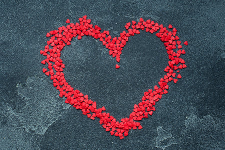 Red sugar hearts on a dark background. Concept Valentine's Day.の写真素材