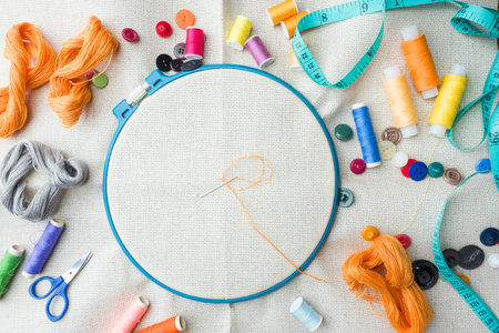 Embroidery set. White linen fabric, embroidery hoop, colorful threads and needls. Copy space
