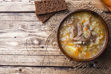 Kharcho soup with meat and rice on wooden table.の写真素材