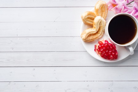 Valentine's day Breakfast concept. Cup of coffee and a cookies hearts on a white table. copy space, flat layの写真素材