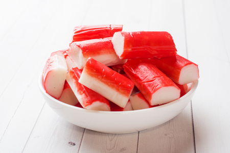 Salad crab sticks in a plate on a white tableの写真素材