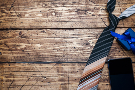Father's Day Concept. Striped tie and a gift on wooden background with copy spaceの写真素材
