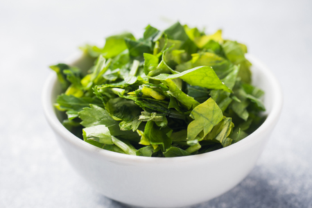 Chopped parsley leaves in a plate. Close up.の写真素材