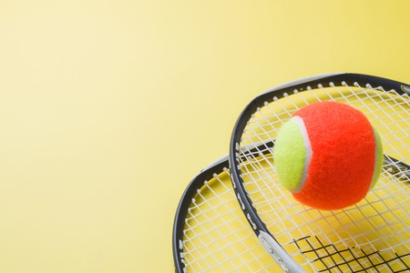 Tennis Ball and rackets on yellow Background, Sport Concept and Ideaの写真素材