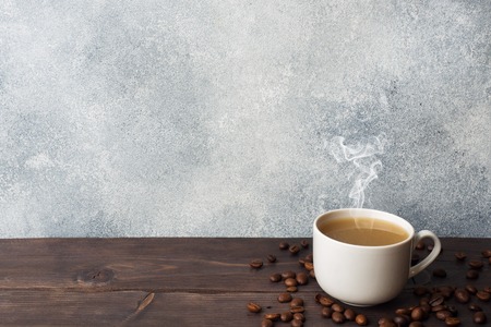 Coffee Cup and coffee beans on wooden background. Copy space.の写真素材