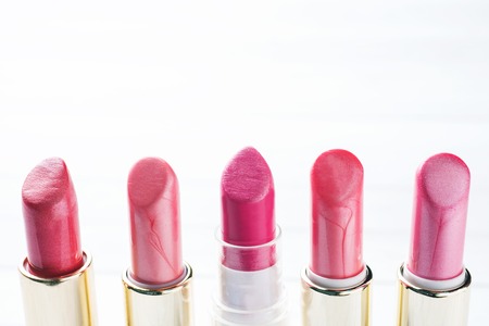 Set of colored pink lipsticks on whiteの写真素材