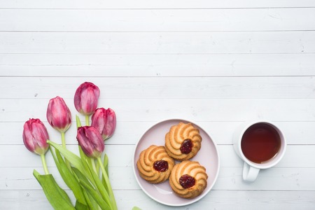 Overhead view of a bouquet of tulips and a Cup of coffee. copy space. Flat lay, top view.の写真素材