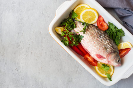 Raw carp fish with spices and vegetables for cooking. The view from the top. Copy space