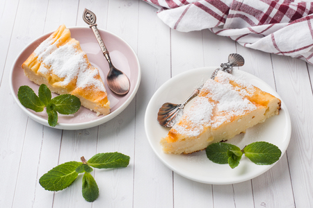 Cottage cheese casserole on a plate with powdered sugar and mint leaves Selective focusの写真素材