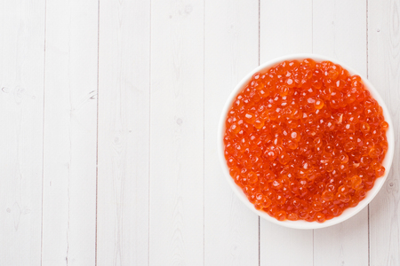 red salmon caviar in a plate on a white table Copy spaceの写真素材