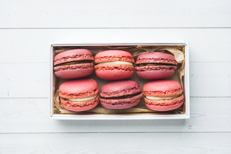 Pink dessert macaron or macaroons in a box on a whiteの写真素材