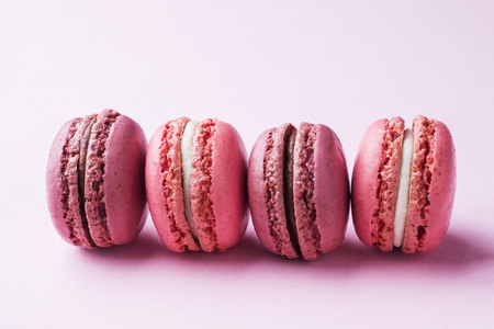 Pink dessert macaron or macaroons on pinkの写真素材