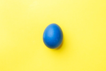 Colorful Easter eggs on yellow background. Copy spaceの写真素材