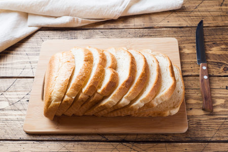 Pieces of white bread loaf for toast on a wooden table