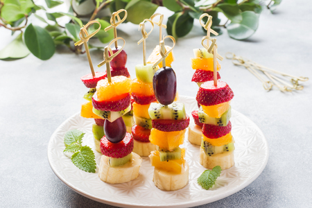 Fresh fruit on skewers. Concept buffet for a summer partyの写真素材