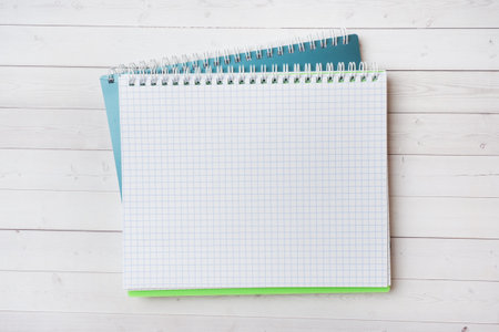 Clean white notebook and pencil with copy space on white table background for presentation, writer...