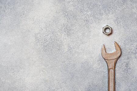 Wrenches, tools bolts and nuts on grey concrete background with copy spaceの写真素材