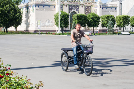 Moscow, Russia - June 24, 2019: Adult man on a modern tricycle in the Park VDNH in Moscowのeditorial素材