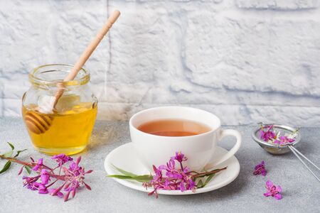 Useful herbal tea from fermented leaves fireweed on grey background. Traditional Russian Koporye Tea Ivan Chai Copy spaceの写真素材