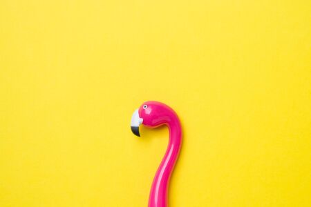 Pink pen Flamingo on a yellow background. Copy space Flat layの写真素材
