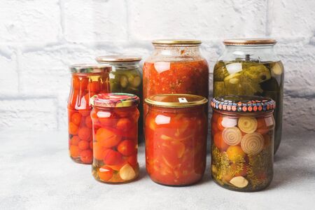 Preservation of vegetables in banks. Fermentation products. Harvesting cucumbers and tomatoes for the winterの写真素材