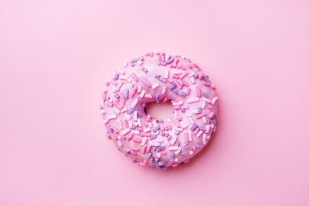 Pink doughnut on a pink background. Top view Flat layの写真素材
