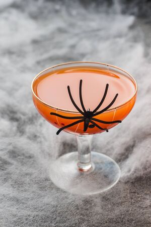 Fresh pumpkin juice. Concept Halloween celebration. Background of spider webの写真素材