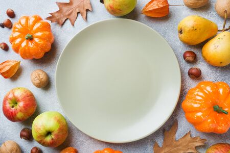 Autumn background with yellow leaves, pumpkins apples pears and nuts. Copy spaceの写真素材