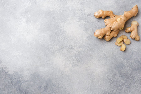 Fresh ginger root on grey background. Copy space
