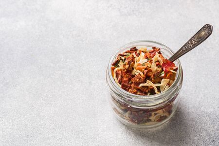 Dried spices, sun-dried tomatoes, dried carrots, Basil and herbes de Provence in a glass jar.の写真素材