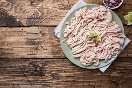 Raw minced chicken on a plate with spices and lime. Wooden background Copy spaceの写真素材