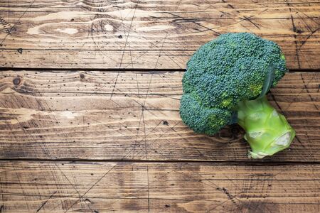 Fresh head of broccoli on a wooden table.の写真素材