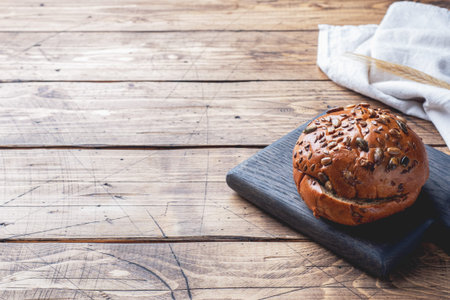 Bread products with cereals and seeds on a wooden background. Lean healthy buns, carbohydrate...