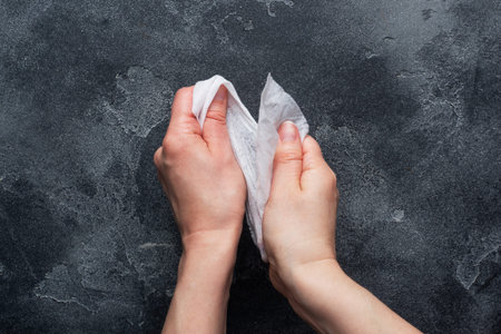 Hands are wiped with a damp antibacterial cloth. The concept of hand cleanliness and the fight...