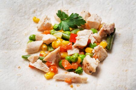 Stewed chicken with vegetables corn pepper tomato peas beans on tortillas. Filling for the Mexican dish quesadillaの写真素材