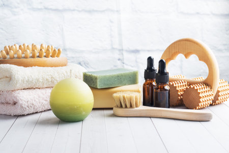 Concept SPA and Wellness. Massage brush, cosmetic oils and soap. Light background Copy space