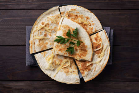 Profiteroles with custard and powdered sugar on a plate. Concrete gray table. Copy spaceの写真素材