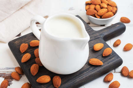 Almond milk in ceramic milk jug on a gray background. Copy spaceの写真素材