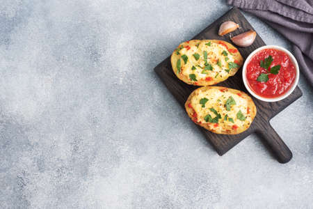 Baked potatoes in the peel stuffed with cheese with garlic and herbs Copy spaceの写真素材