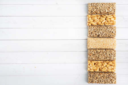 Oriental sweetness of brittle, Kozinaki in sugar glazed peanuts, sunflower seeds and sesame seeds top view copy spaceの写真素材