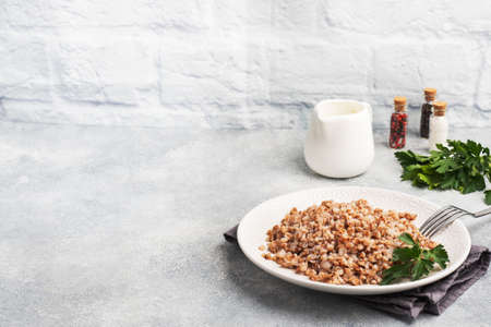 Boiled buckwheat on a plate. Healthy porridge enriched with vitamins copy space,の写真素材