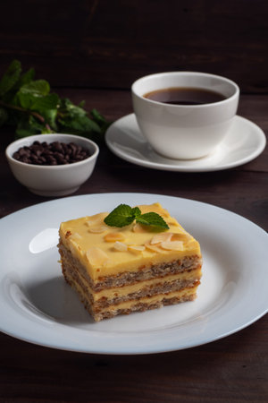 Banana sponge cake with nuts and mint. Delicious sweet dessert for tea, Dark wooden background