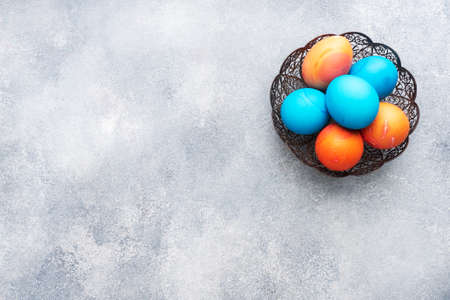 Easter eggs painted by hand colored on a concrete table, top view. copy space.の写真素材
