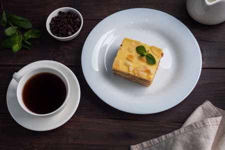 Banana sponge cake with nuts and mint. Delicious sweet dessert for tea, Dark wooden backgroundの写真素材