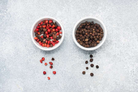Pepper peas black and red in plates, gray concrete background copy spaceの写真素材