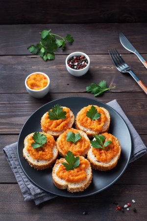 Sandwiches with bread zucchini caviar tomatoes onions. Homemade vegetarian food. Canned stewed vegetable wooden background copy spaceの写真素材
