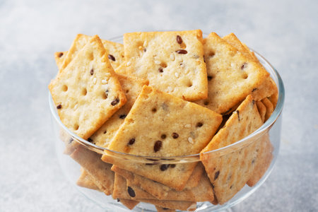 Delicious healthy cookies crackers with flax seeds and sesame seeds on a plate. Background of a...