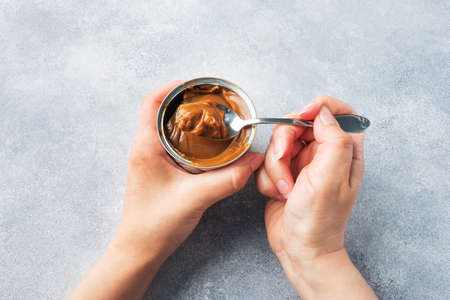 Boiled condensed milk in a tin can. Sweet pasta spread for Breakfast and dessert. Copy spaceの写真素材