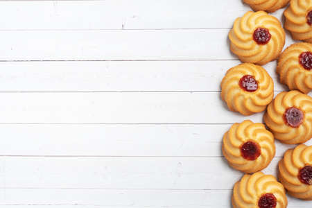 Kurabye shortbread cookies with berry jam on white background. Delicious dessert, copy spaceの写真素材