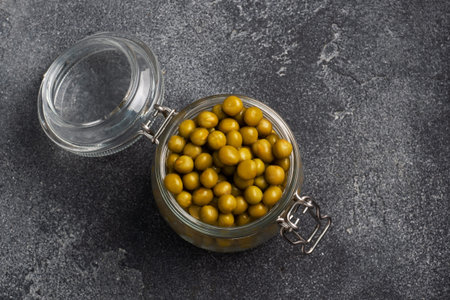 Canned green peas in a glass jar. Homemade fermented food copy space